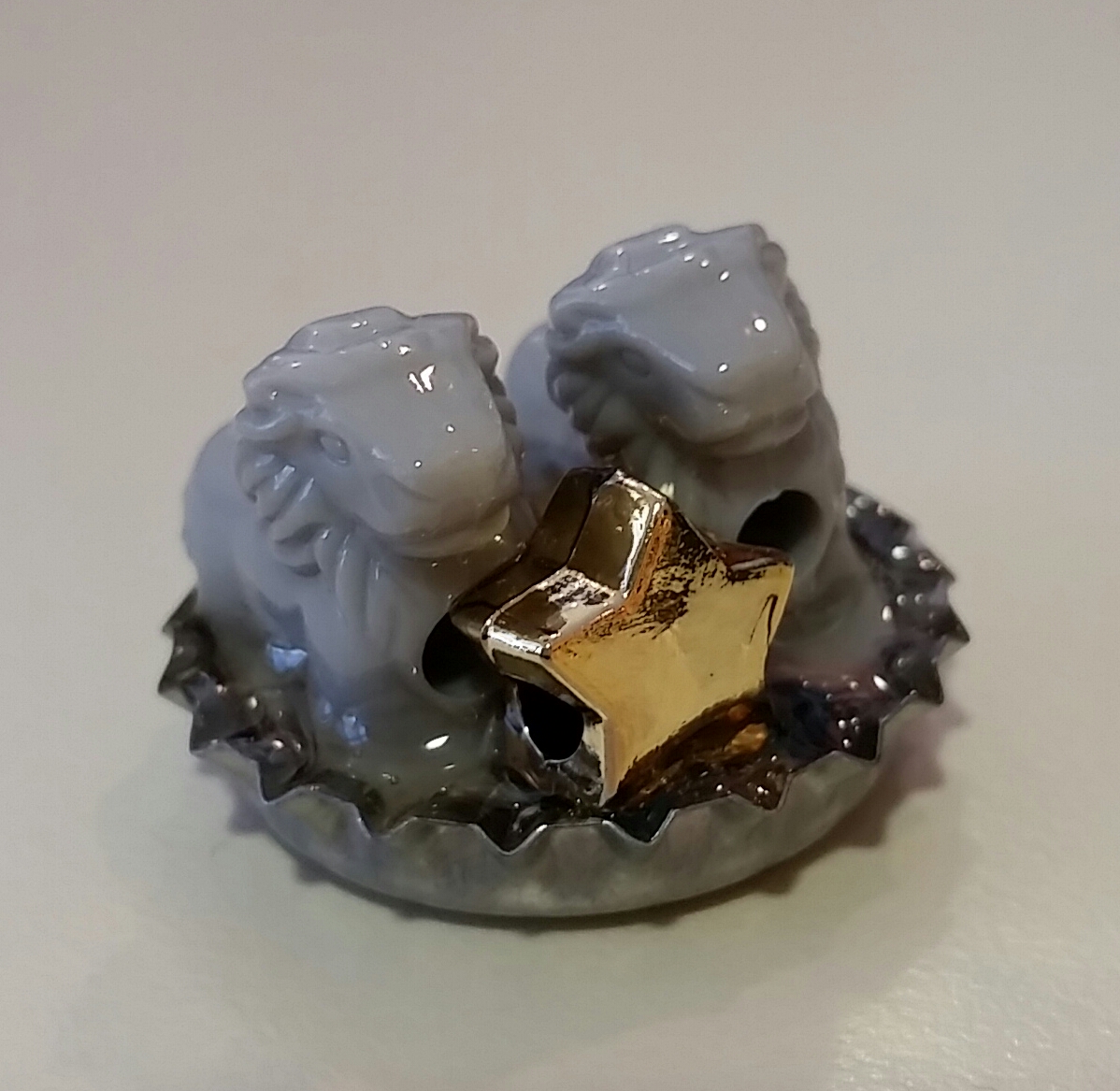 Capsters Photo of two small plastic animals in a bottle cap