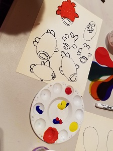 Photo of a child's drawing and a paint palette