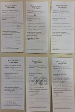 Photo of six pieces of paper forms filled out in pencil