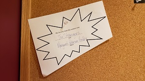 Photo of a bulletin board with a piece of paper on it