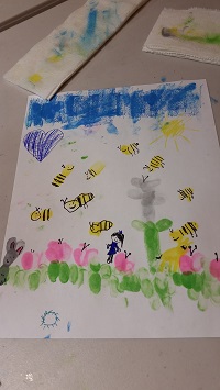 Photo of a child's artwork made with fingerprints and ink drawing