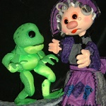 The Frog Prince puppets Photo of two puppets a green frog and a woman in a purple dress