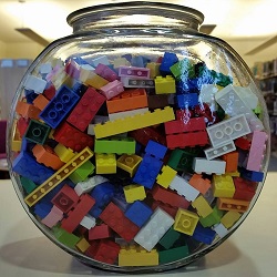 Photo of a glass fishbowl filled with lego bricks