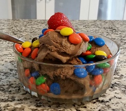 Photo of a bowl of chocolate ice cream with M and M candies on top