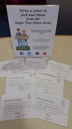 Photo of postcards and a sign that says write a postcard to Jack and Annie