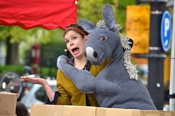 Photo of a woman with a large gray donkey puppet