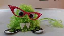 Monster! Photo of a small green monster toy made out of a pompom