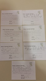 Photo of four postcards written by children