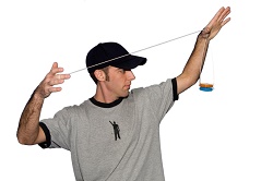 Photo of a man in a baseball cap doing a trick with a yo-yo