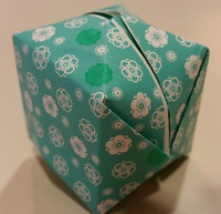 Photo of an origami box made of blue flowered paper