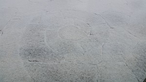 Photo of a stone patio with a light dusting of snow on it