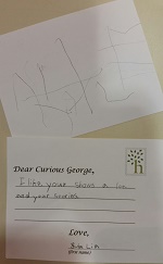 Photo of two postcards written by a child to curious george
