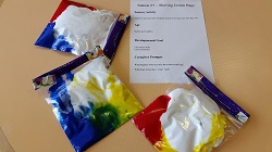 Photo of three ziploc bags filled with shaving cream and paint in different colors