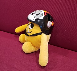 Nibbles in a Bike Helmet Photo of a yellow stuffed animal monster in a bike helmet