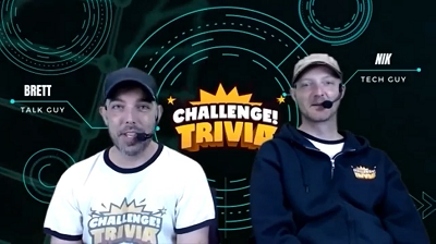 Photo of two men with headsets in front of a sign that says Challenge Trivia
