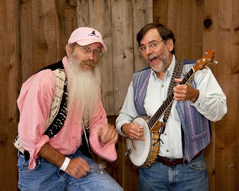 Photo of a man playing a banjo and a man playing spoons