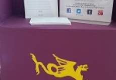 Photo of a child's purple mailbox with hpl mail and a dragon painted on it