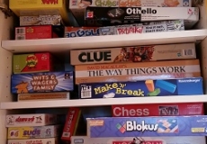Game Hour games Photo of a large selection of board games in a cabinet