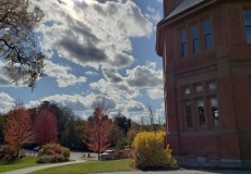 HPL November sky Photo of a brick library building against a blue sky with sun and clouds