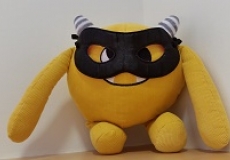 Halloween Nibbles Photo of a yellow stuffed animal monster wearing a black eye mask