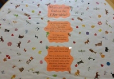 Photo of a child's table covered with a sheet of paper that has stickers on it