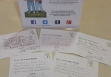 Photo of postcards and a sign that says write a postcard to Jack and Annie