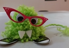 Monster! Photo of a small green monster toy made out of a pompom