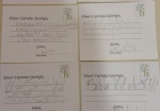 Photo of four postcards written by children