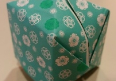 Photo of an origami box made of blue flowered paper