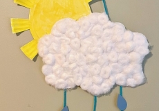 Photo of a yellow sun made of a paper plate and a white cloud made of cottonballs