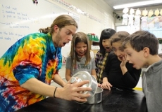Sciencetellers Aliens Photo of a teacher showing four children an exciting science experiment