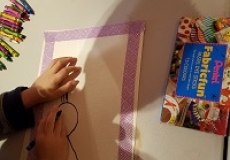 Self Portraits Photo of a piece of paper and a child's hands drawing on the paper