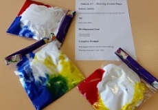 Photo of three ziploc bags filled with shaving cream and paint in different colors
