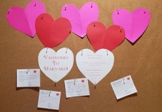 Photo of a bulletin board with paper hearts