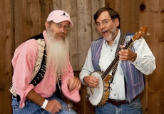 Photo of a man playing a banjo and a man playing spoons